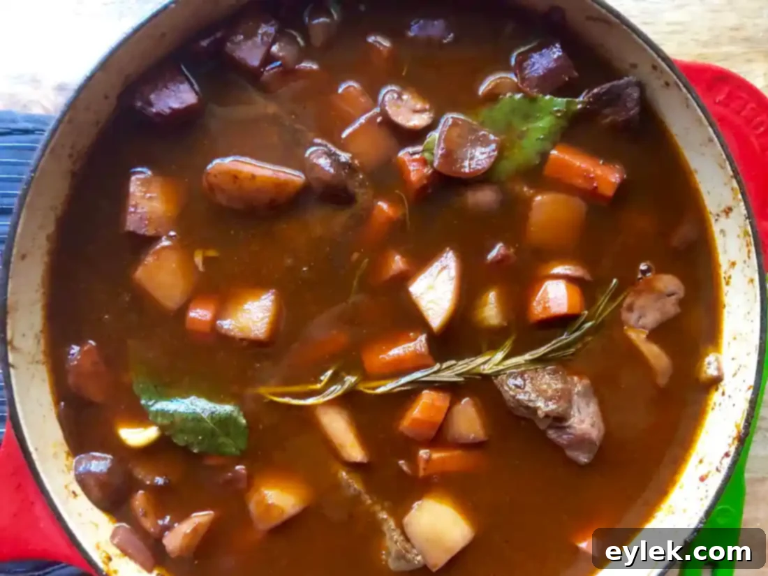 Braised beef stew cooking slowly in the oven, creating tender meat