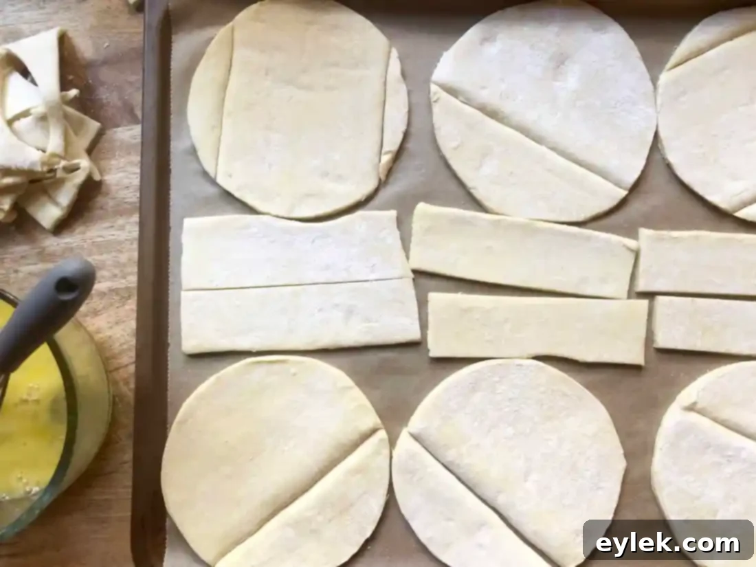 Puff pastry rounds arranged on a baking sheet, ready for egg wash