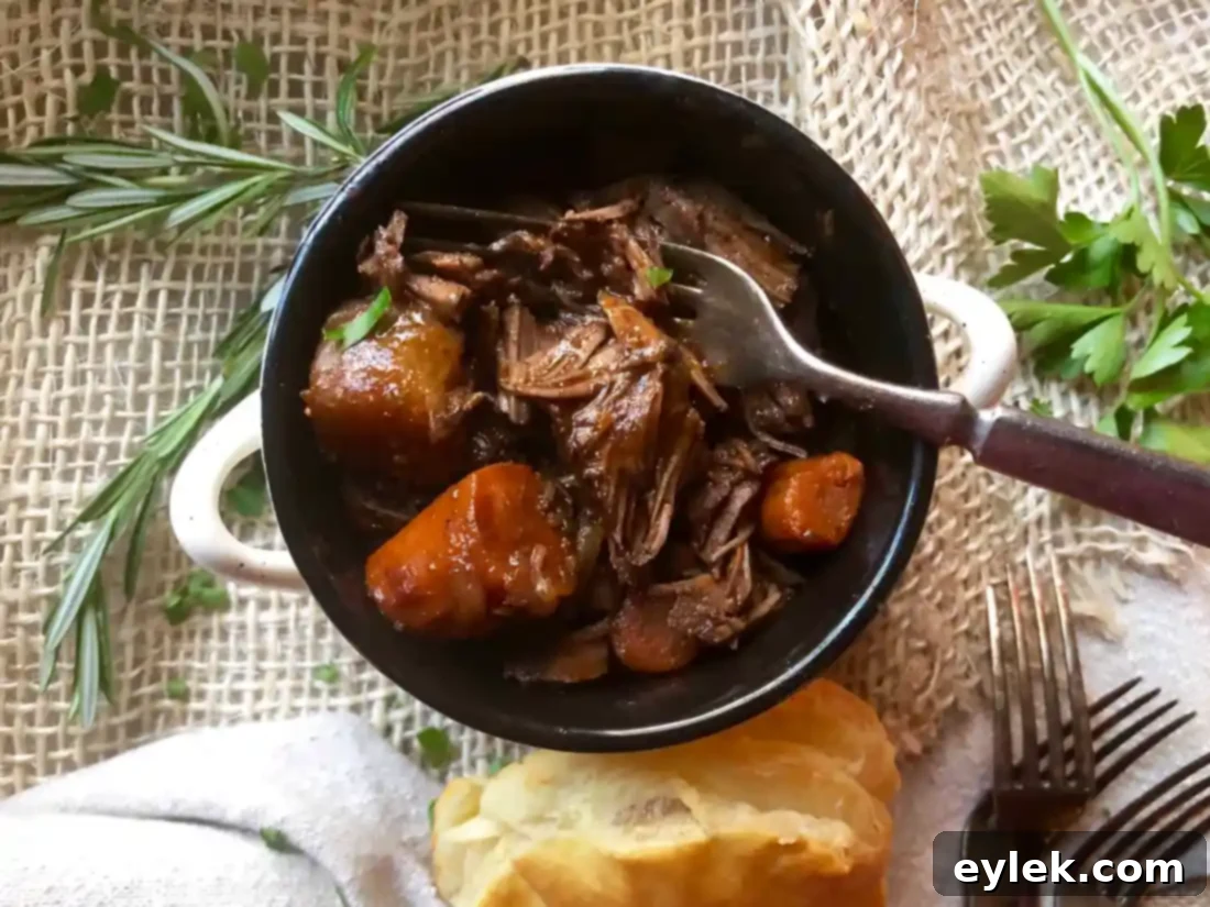 Individual serving of braised beef stew topped with flaky puff pastry