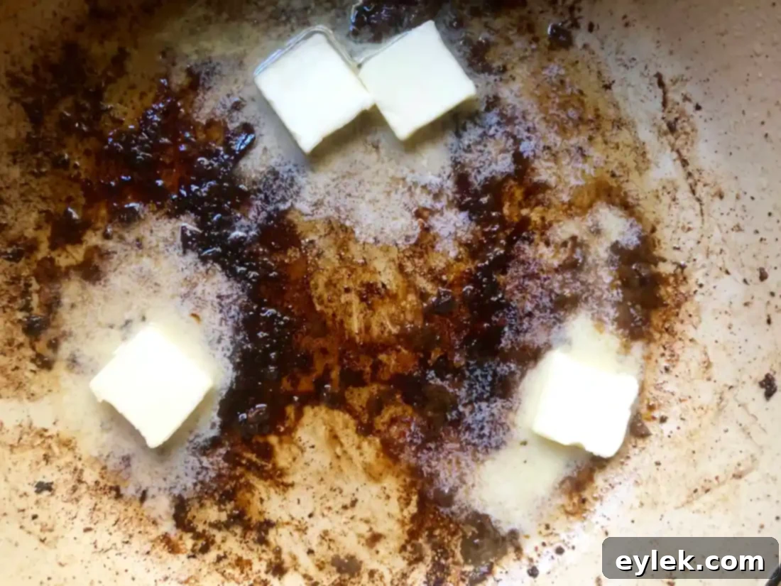 Close-up of browned bits and drippings at the bottom of a pot