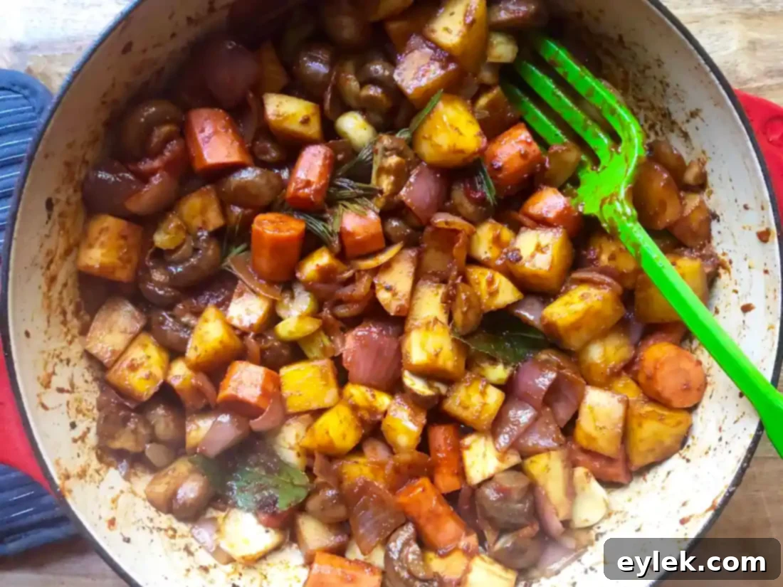 Red wine poured over vegetables and tomato paste for braising