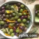 Ina Garten's Warm Marinated Olives appetizer with herbs and olive oil