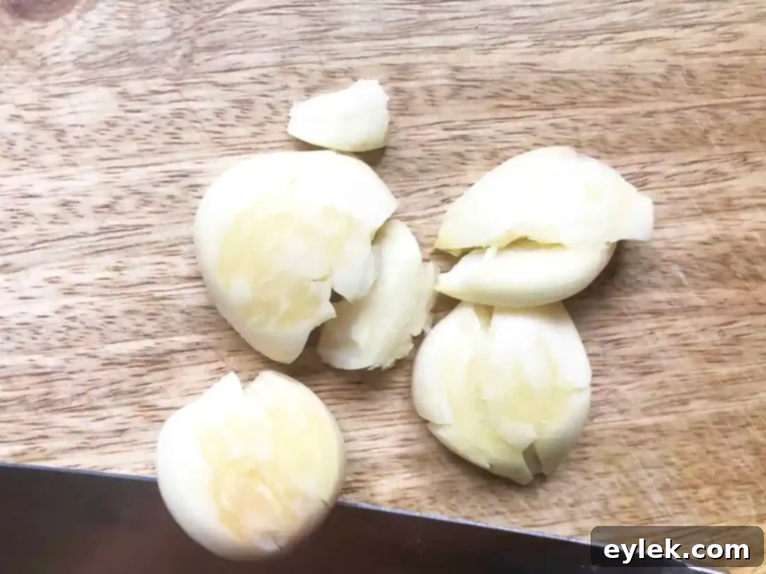 Preparation of garlic and fennel seeds for Ina Garten's Warm Marinated Olives recipe.