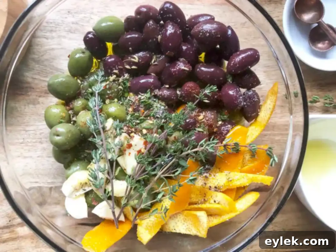 Marinated olives in a bowl, showing the vibrant mix of ingredients before heating.