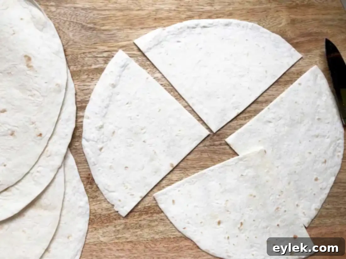 Placing filler tortilla piece on top of ingredients before folding