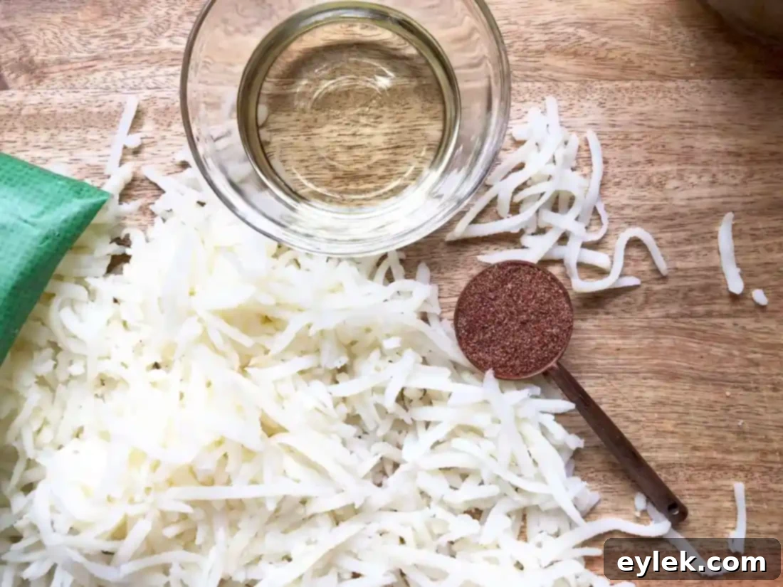 Crispy taco-flavored hash browns cooking in a skillet