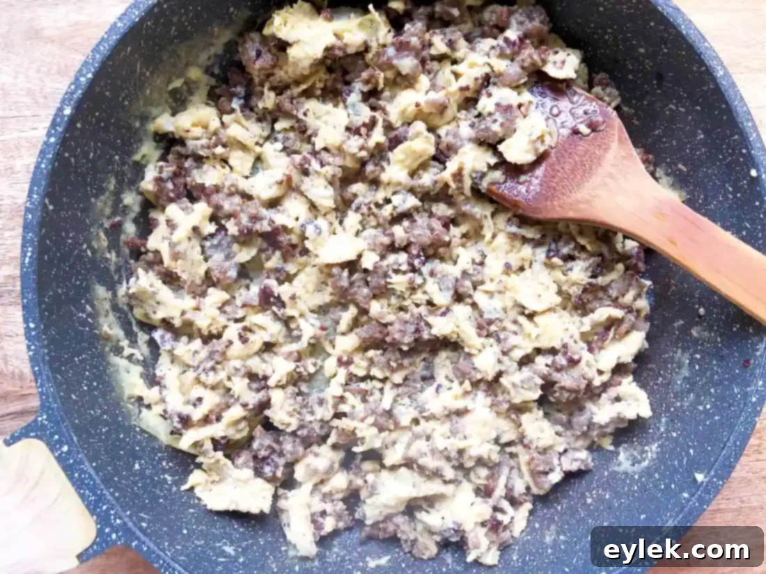 Adding sausage and egg mixture to the crunchwraps