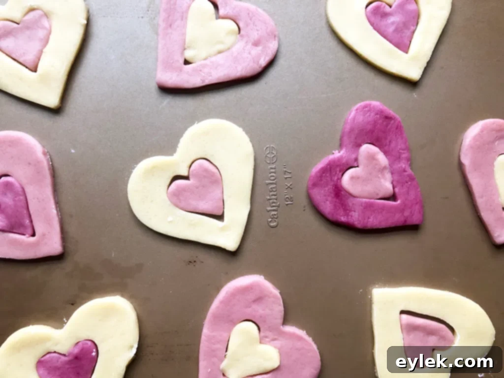 More patchwork heart cookies arranged on a baking sheet