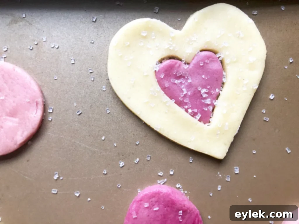 Heart cutout cookies dusted with sparkling sugar before baking