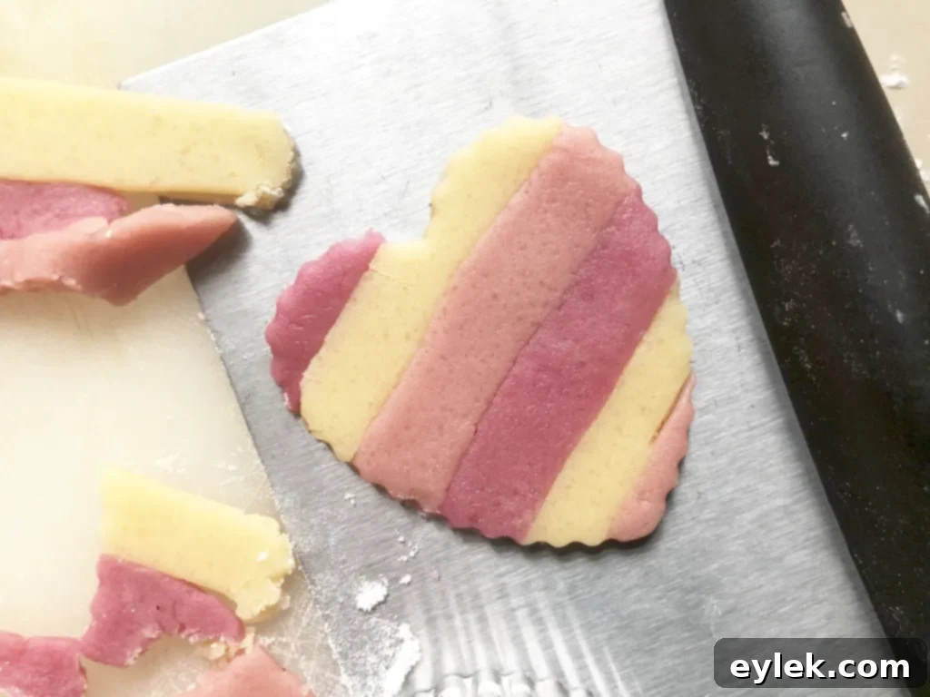Arranging colored cookie dough strips side by side
