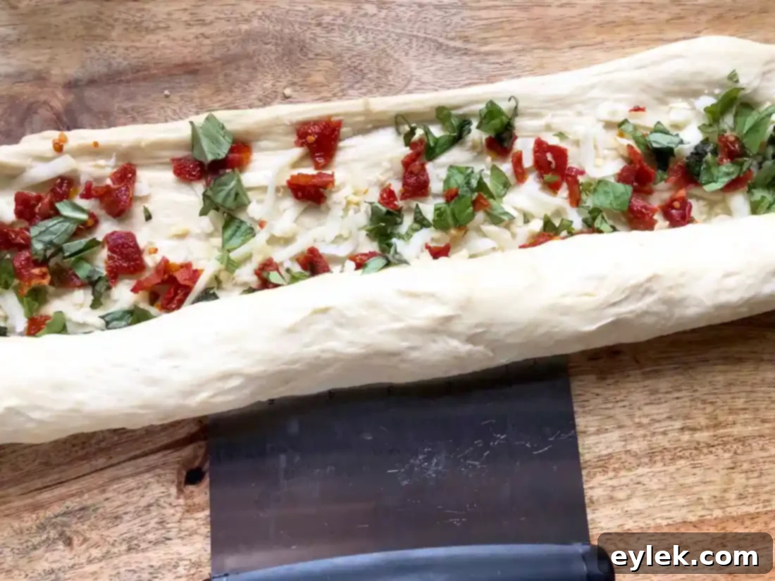 pane bianco dough being rolled into a log