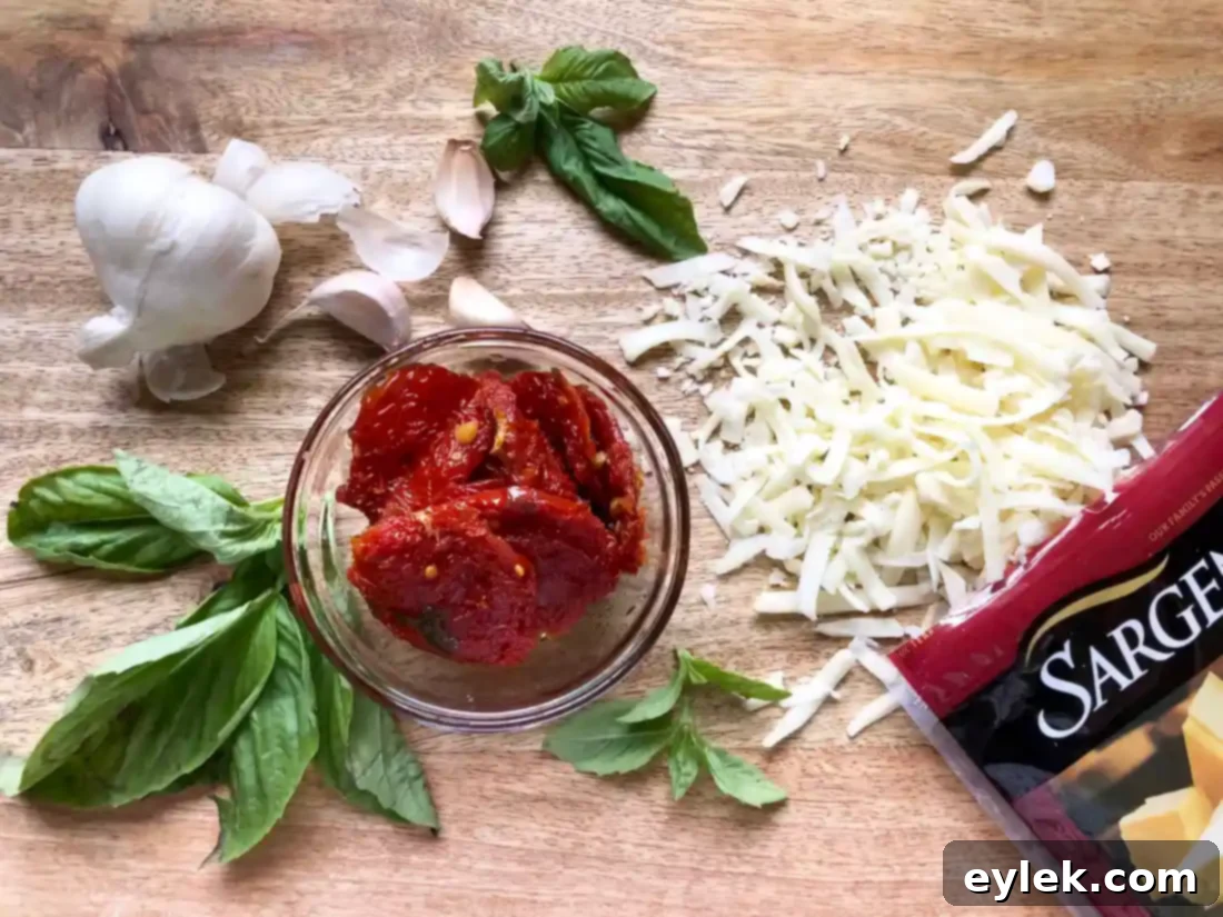 ingredients for pane bianco filling including sun-dried tomatoes, cheese, garlic, and basil