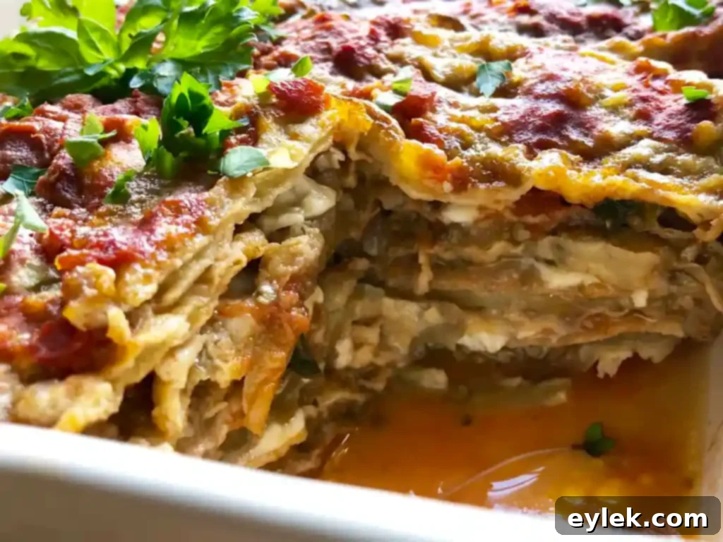 A slice of Authentic Eggplant Parmesan on a plate, garnished with fresh basil