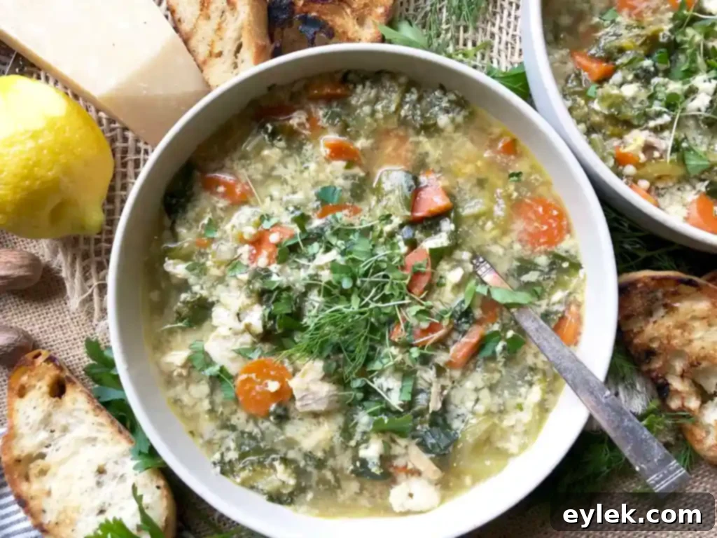 A rustic bowl of Chicken Escarole Soup with Egg & Pasta, perfect for a cozy meal.