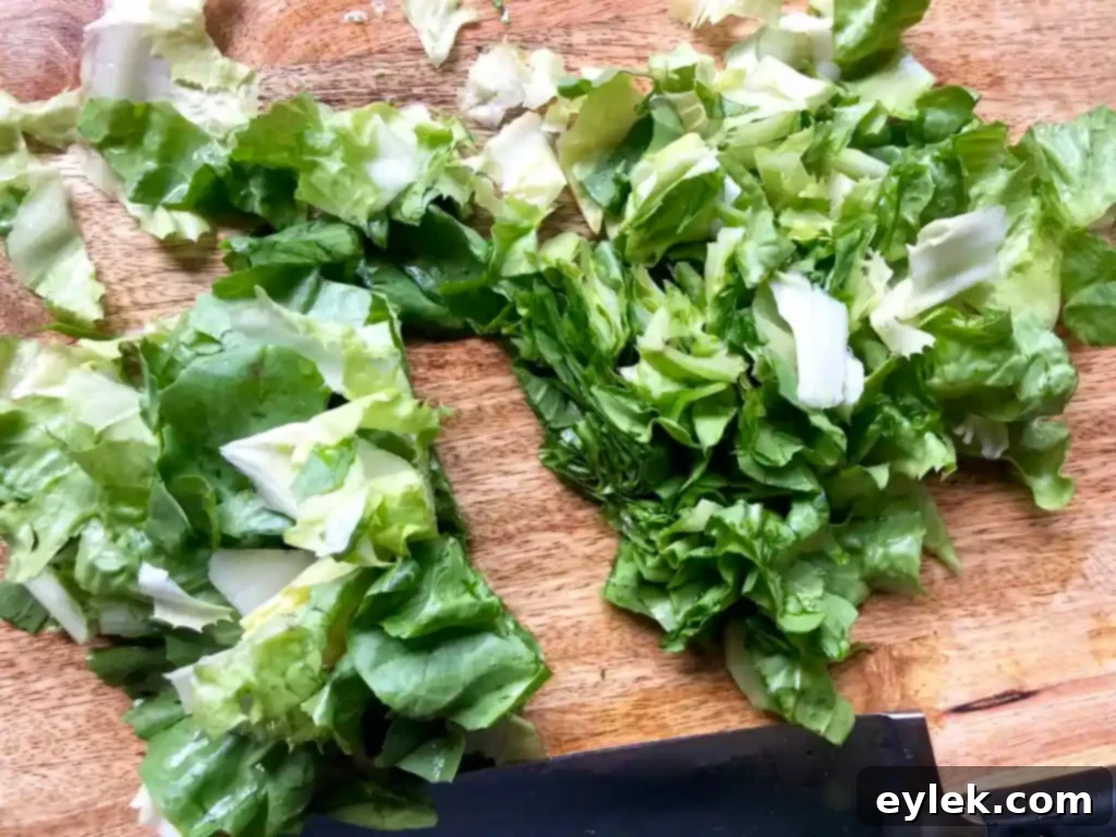 Cooking acini de pepe pasta in the flavorful chicken escarole soup broth.