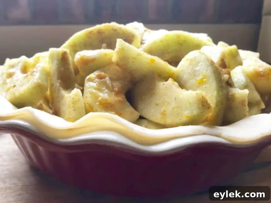 Applying egg wash to the entire top crust of an unbaked pie