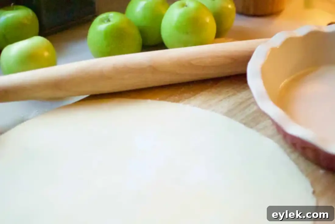 Mixing apple slices with citrus zest and spices for Ina Garten's Deep Dish Apple Pie