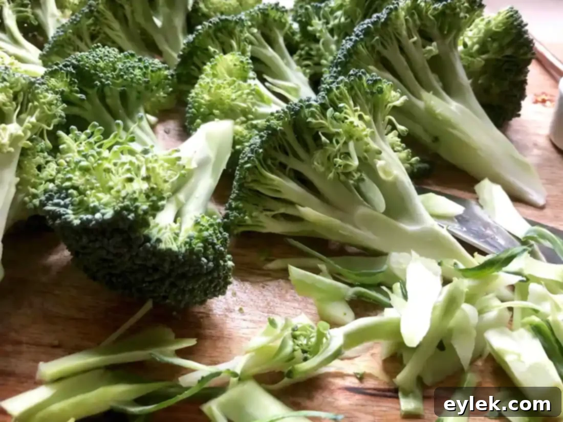 Smoky Marinated Broccoli Spears 3 Fresh broccoli being trimmed into spears for grilling