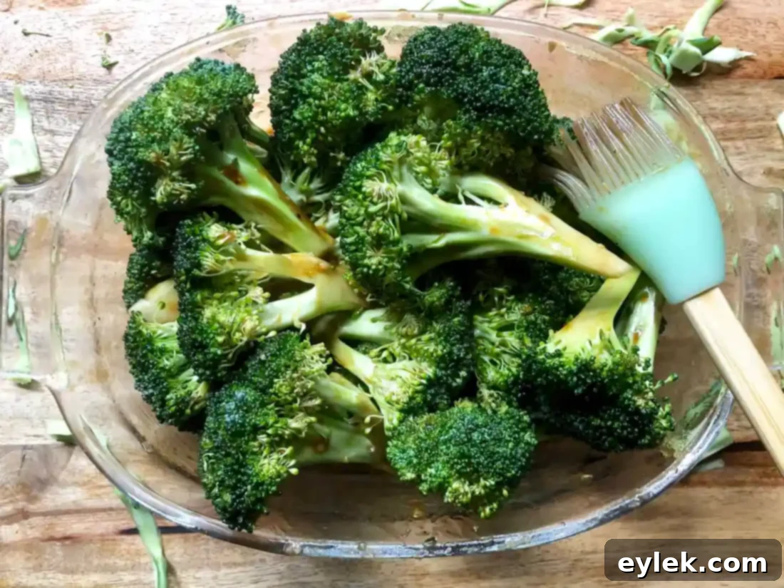Smoky Marinated Broccoli Spears 7 Broccoli spears being tossed in the marinade