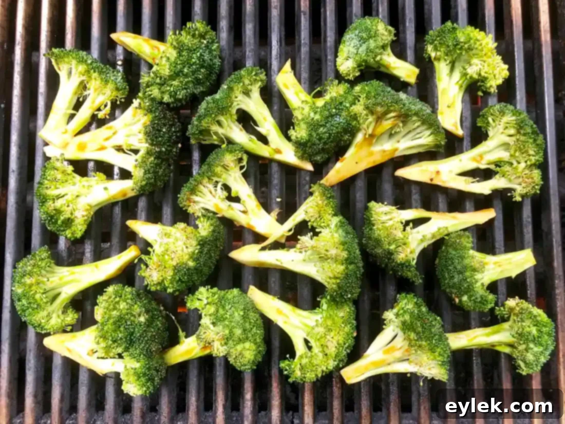 Smoky Marinated Broccoli Spears 8 Broccoli spears grilling on an outdoor barbecue