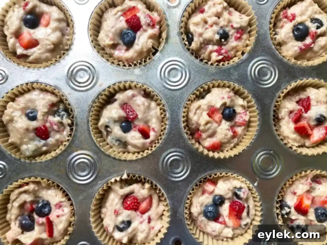 Triple Berry Muffins Gluten Free or Classic 10 Golden brown triple berry muffins baking in a muffin tin