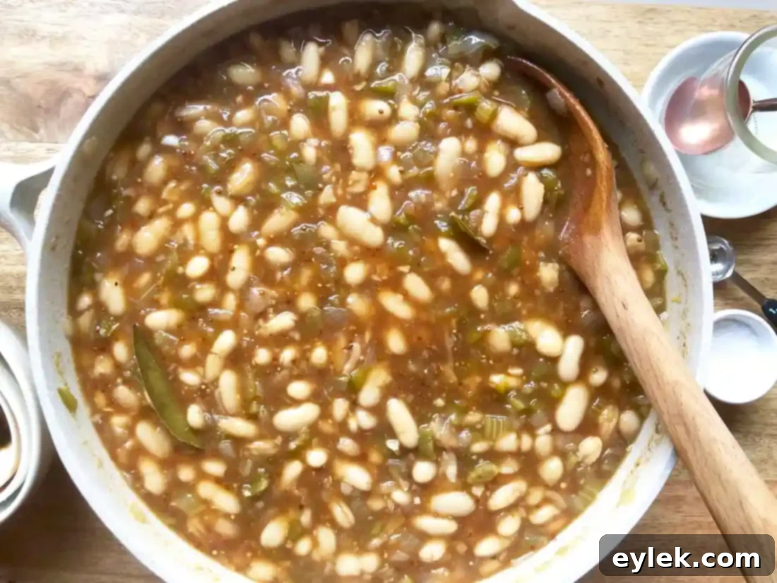 chicken thighs simmering in barbecue beans