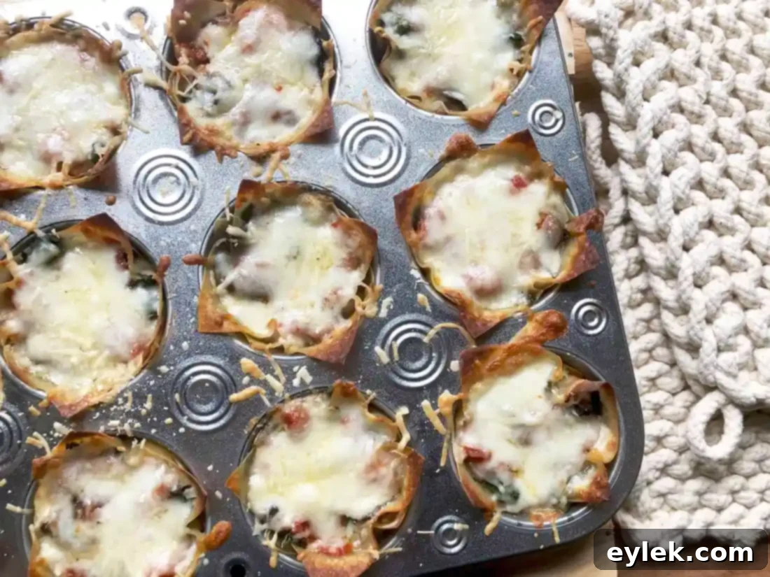 Individual Quick & Easy Veggie Lasagna Cups, freshly baked and garnished with basil.