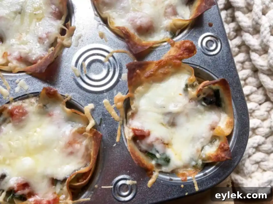 Close-up of the crispy edges and melted cheese on the baked veggie lasagna cups.