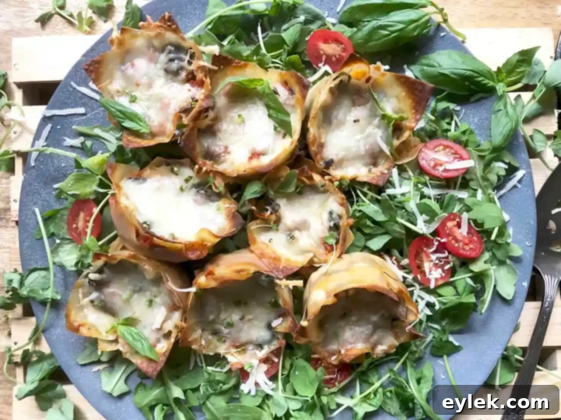 A close-up shot of several baked Quick & Easy Veggie Lasagna Cups, perfectly golden and cheesy.