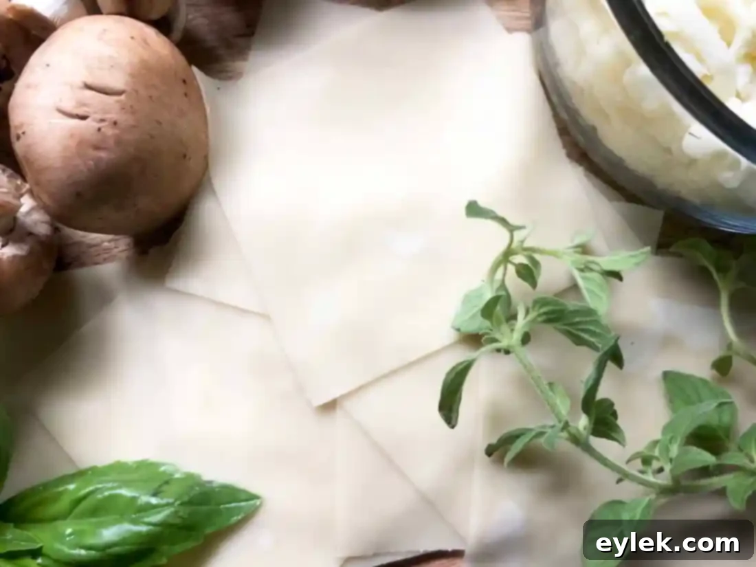 Muffin tin with wonton wrappers, cooking spray used for preparation of veggie lasagna cups.