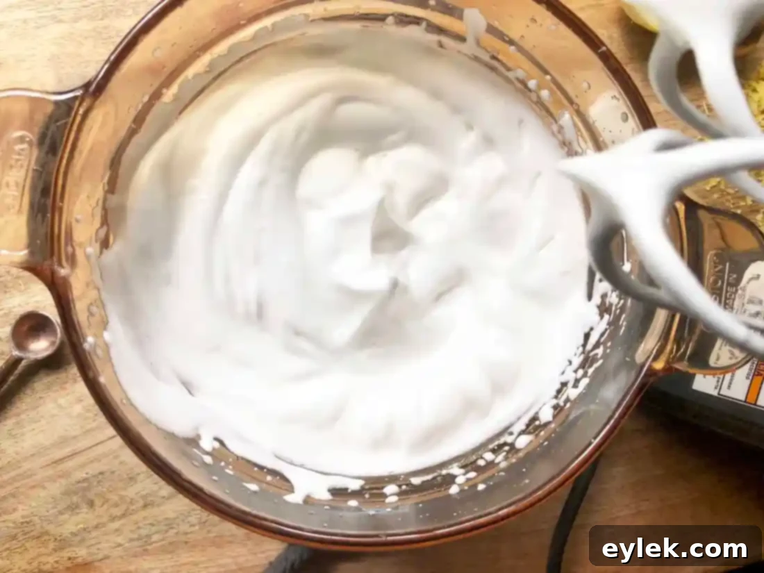 Whipping the egg white and gelatin mixture in a stand mixer