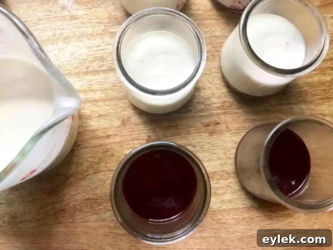 Lemon yogurt mousse poured over blueberry sauce in ramekins
