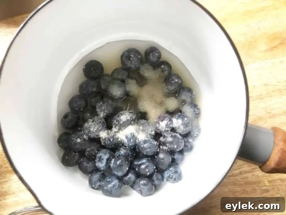 Blueberry sauce simmering and thickening on the stove