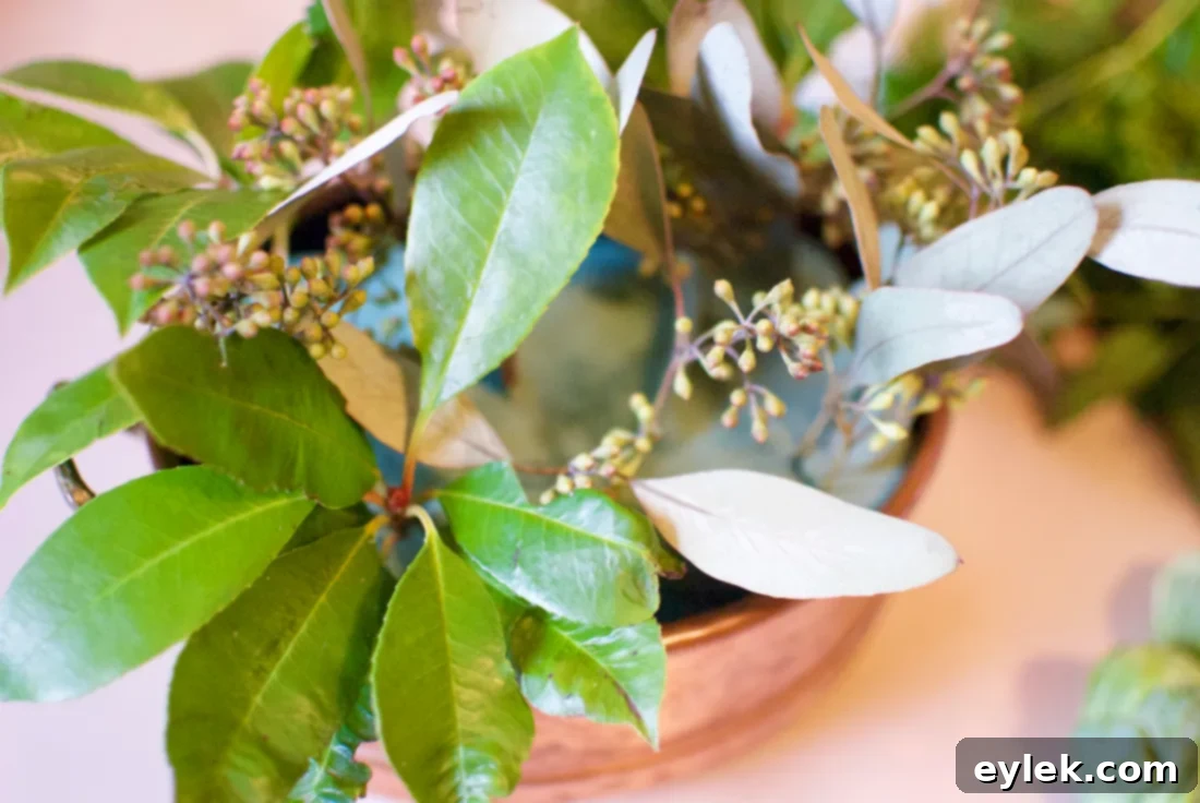 Initial base of green eucalyptus and pink hydrangeas in a vase with florist foam