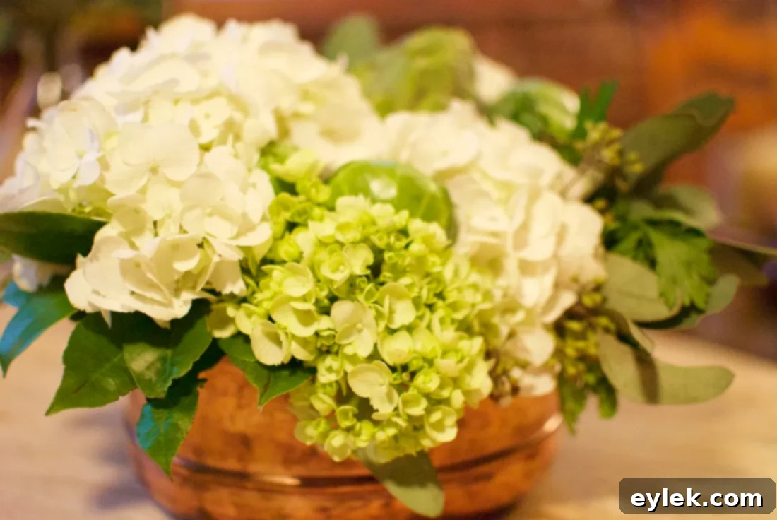 Completed DIY floral arrangement with flowers, eucalyptus, artichoke, and Brussels sprouts