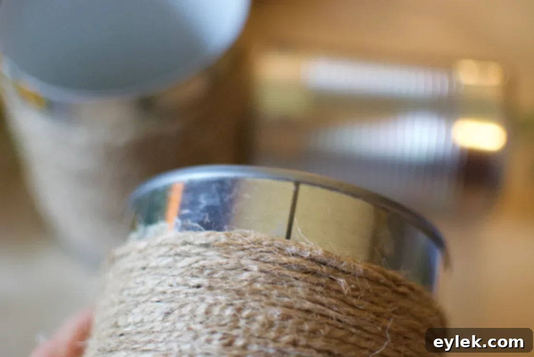 A set of three completed shabby chic tin can planters wrapped in jute twine