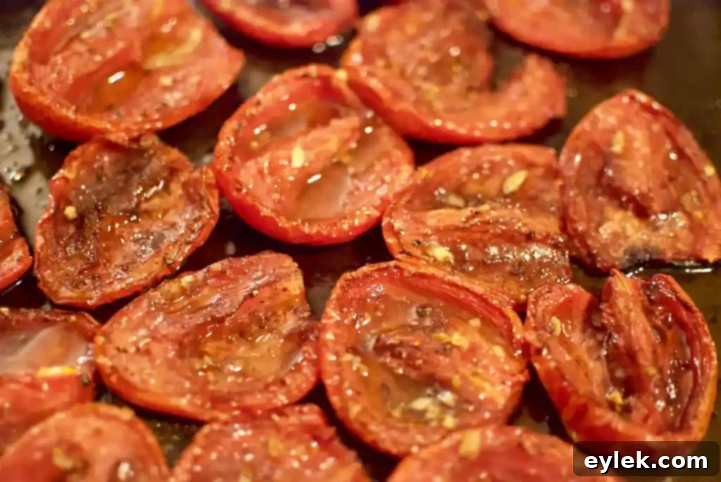 ina garten’s slow roasted tomatoes, finished roasted tomatoes on a baking sheet