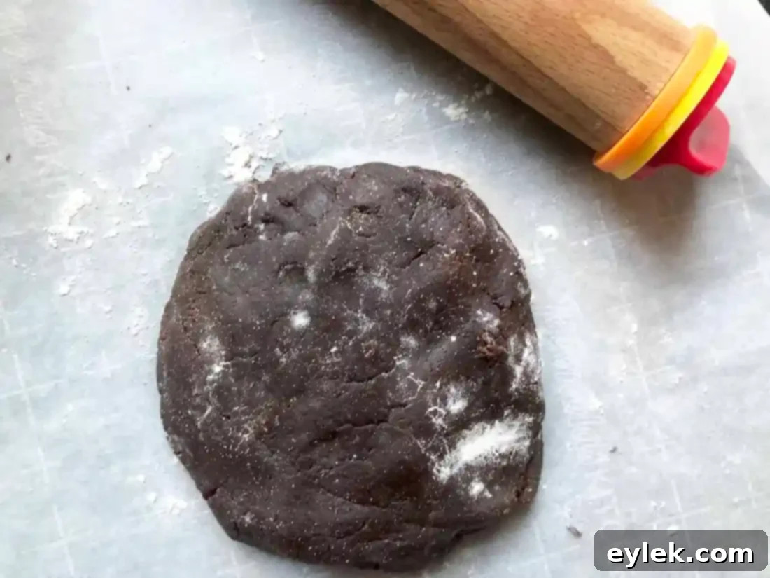 cut dark chocolate wafer cookie dough on baking sheet