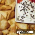 Cannoli Dip Nachos 9 Cannoli dip with tortilla chips and strawberries on a white plate