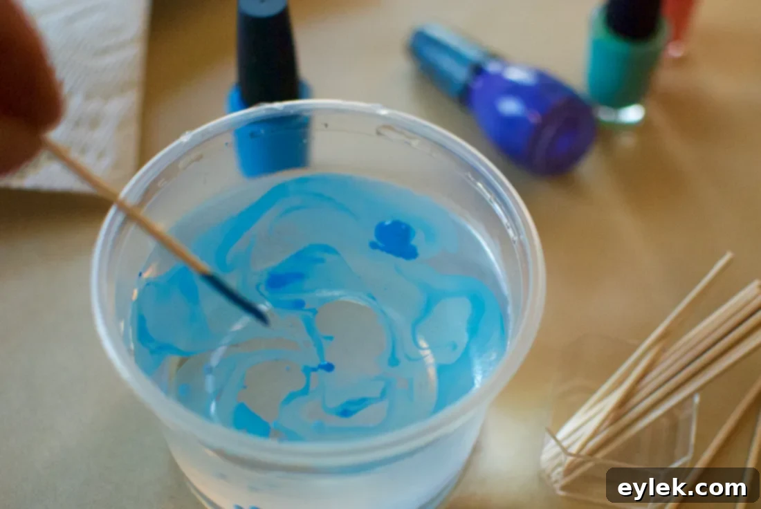 Close-up of a disposable container filled with water, ready for nail polish marbleizing.