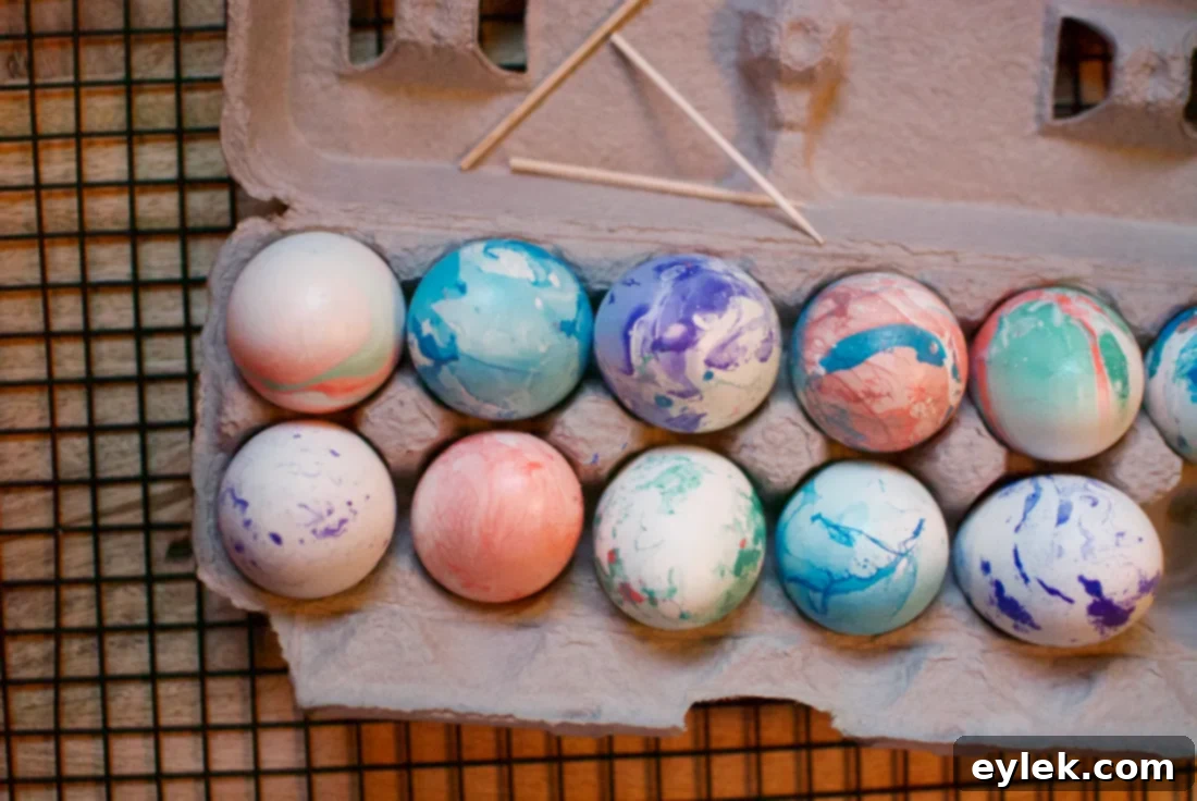 A collection of beautifully marbleized Easter eggs displayed elegantly in a white bowl.