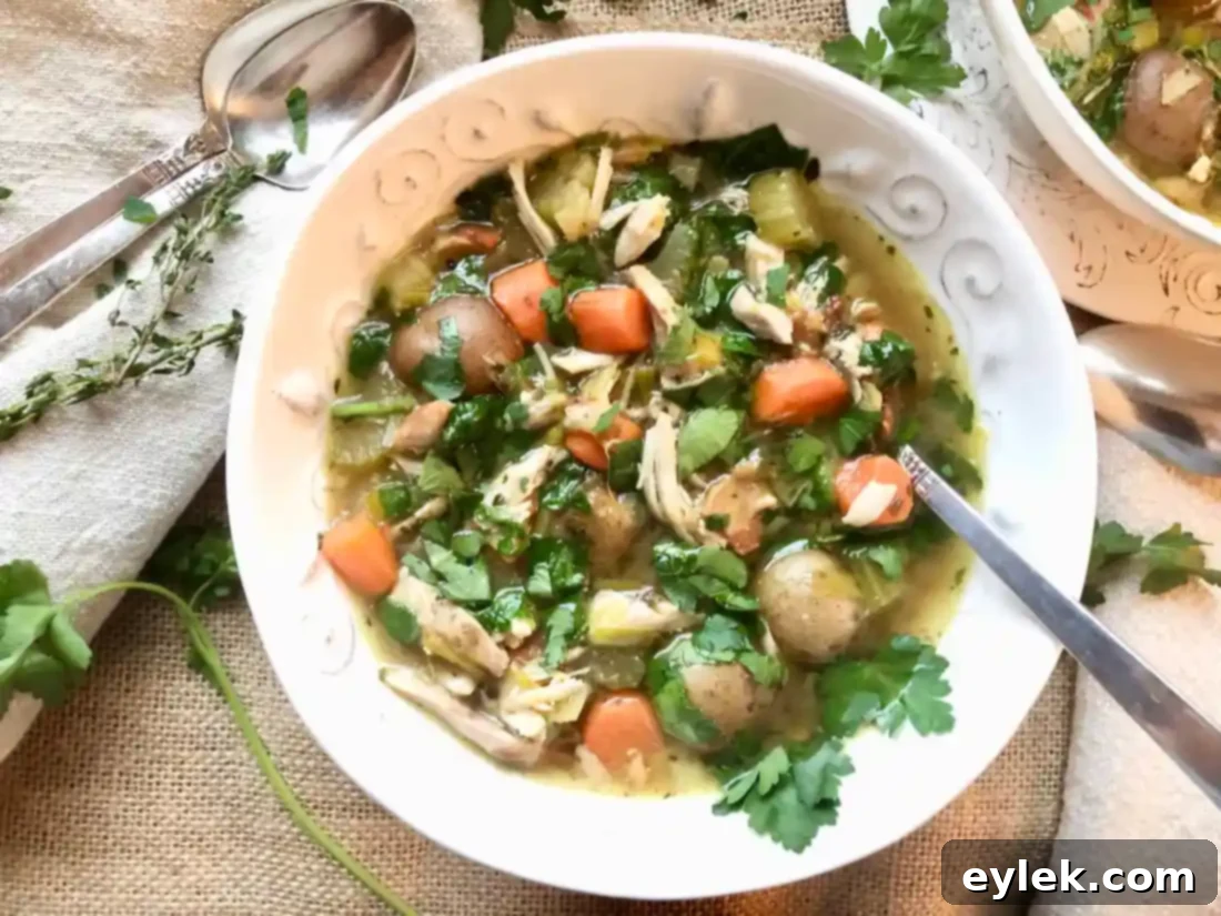 Served Slow Cooker Chicken Soup with Bacon & Potatoes alongside a fresh salad and crusty bread