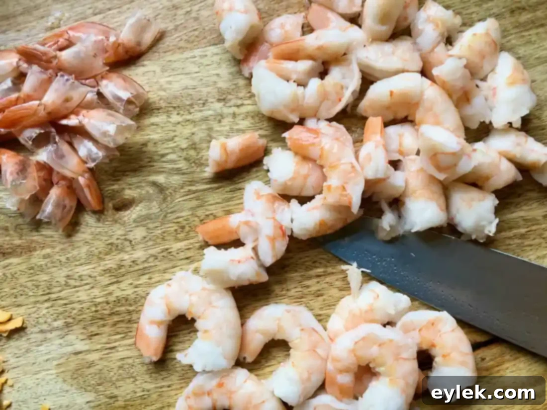Expertly chopped shrimp, ready to be added to the rich queso base.