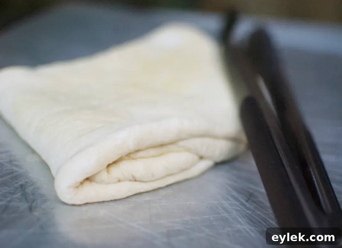 Pizza dough being stretched and prepared for grilling