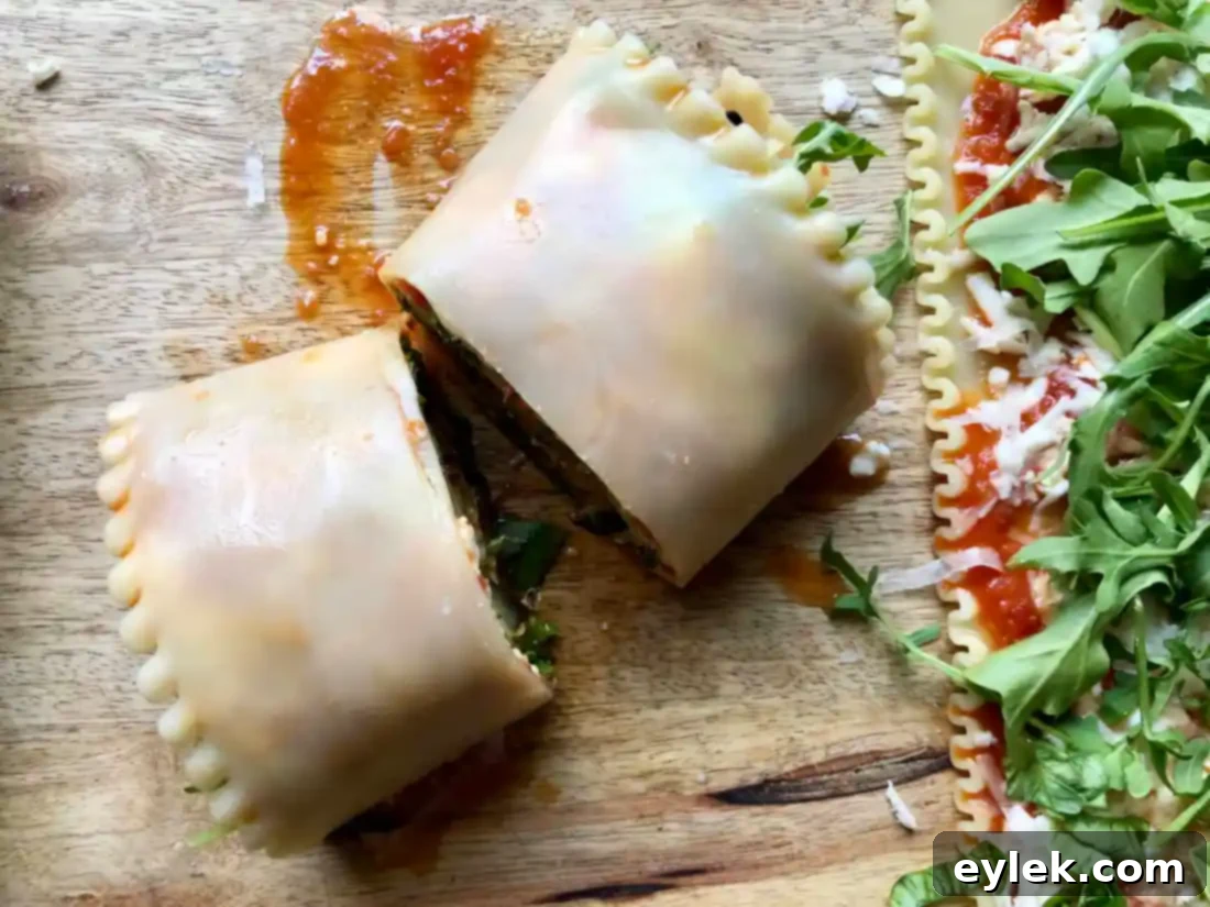 The process of layering lasagna noodles, sautéed eggplant, marinara sauce, and cheeses, then carefully rolling them into tight spirals for baking.