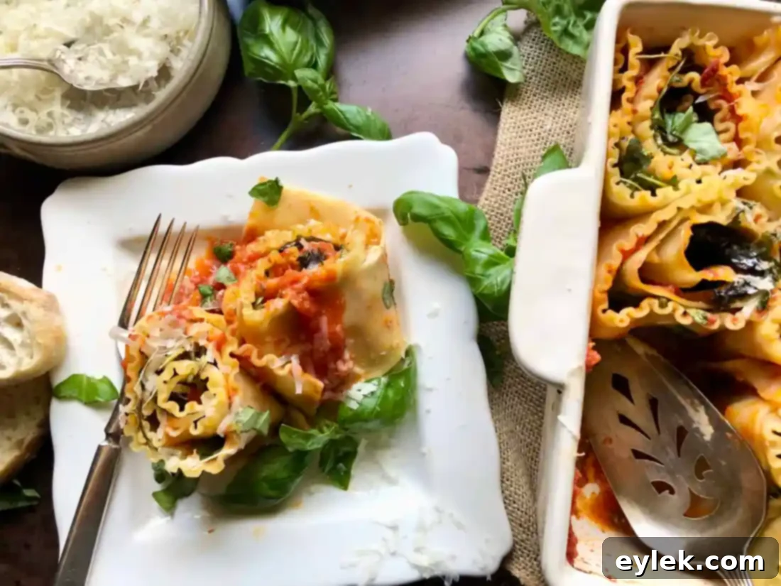Sautéed Eggplant Lasagna Spirals served on a plate with fresh basil garnish and a side of marinara sauce, illustrating a perfect individual serving.