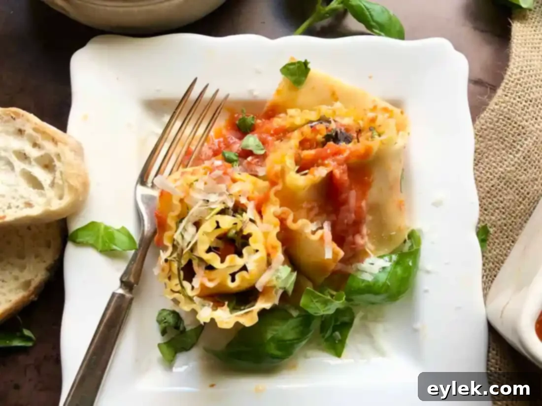 A single Sautéed Eggplant Lasagna Spiral served on a white plate, showcasing the distinct layers and the elegant presentation, garnished with fresh basil.