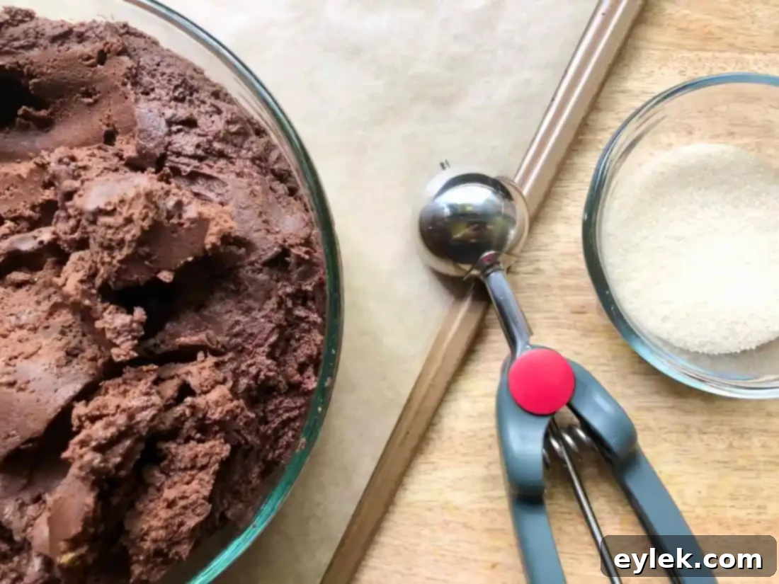 scooping chocolate crackle cookie dough