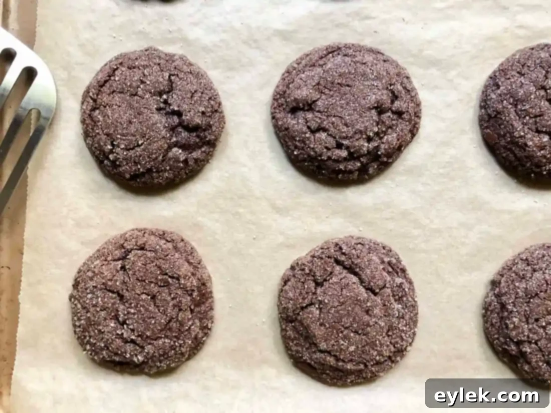 baked chocolate crackle cookies on baking sheet