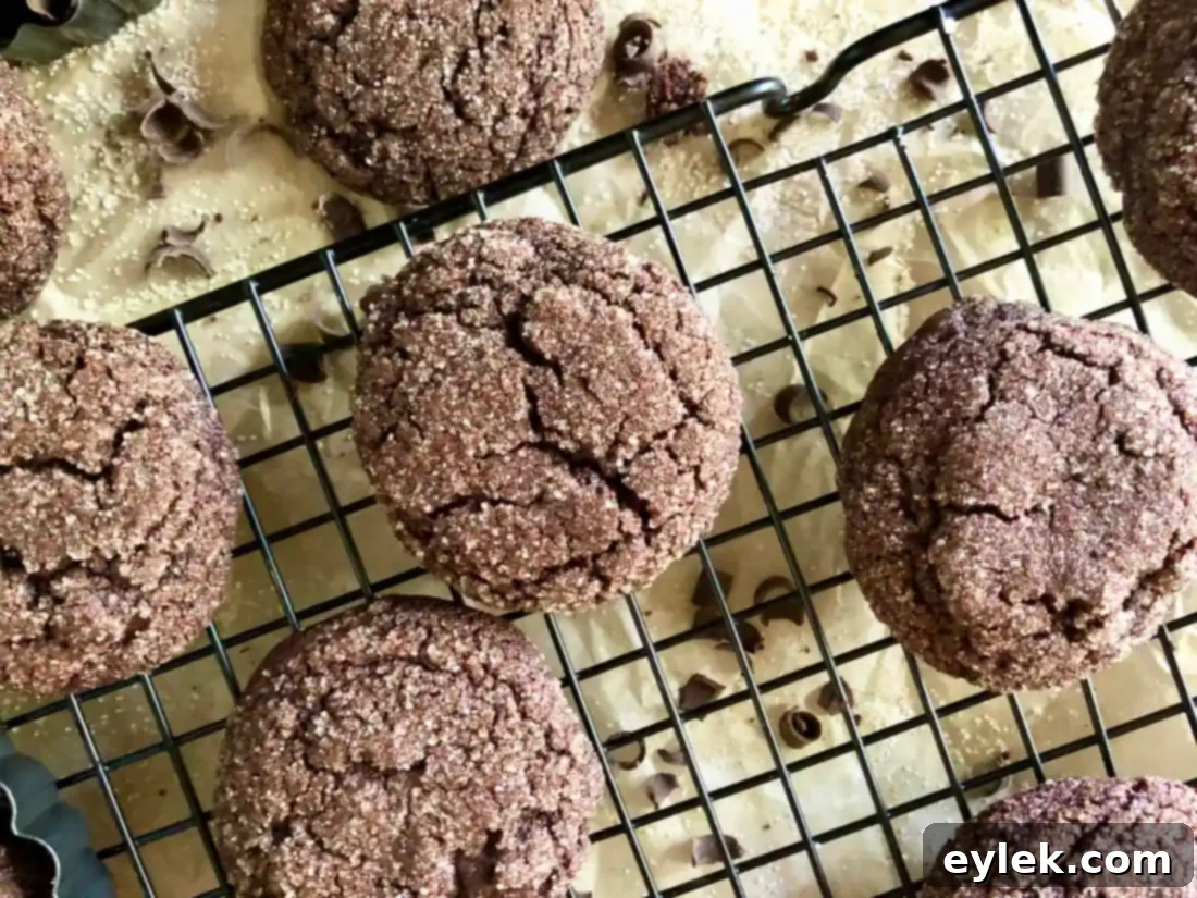 ultra-dark chocolate crackle cookies on a cooling rack